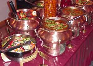 Copper kettle chafing dishes kept warm on the buffet.